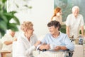 Front view of two happy geriatric women talking and holding hand Royalty Free Stock Photo