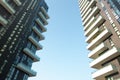 Milan, Italy, March 2020. Front view of two modern unique multi-story buildings in Milan with stunning tones Royalty Free Stock Photo