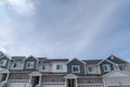 Front view of two storey townhouses in the suburbs against clouds and blue sky Royalty Free Stock Photo