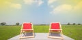 Front view of Two wooden folding chairs For sitting on the lost area The backseat is red and the seat is empty. The background is Royalty Free Stock Photo