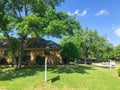 Facade of typical suburban corner house with for sale sign post stake near Dallas, Texas, America