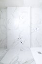 Front view of an unfinished new bathroom with white marbled tiles. Empty background Royalty Free Stock Photo