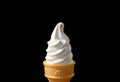 Front View of Vanilla Soft Serve Ice Cream Cone Isolated on Black Background Royalty Free Stock Photo