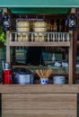 Wooden counter display in front of the restaurant with Pinto, Ceramic bowls, Wooden chopsticks, Stainless steel pot, Chinese retro Royalty Free Stock Photo