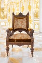 Front view of vintage wooden chair in luxury mirror room or hall decorated with chandelier Royalty Free Stock Photo