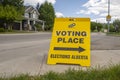 Front view of a Voting Place Elections Alberta sign, yellow double sided floor stand