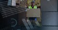 Front view of a warehouse worker loading packages in the back of a delivery van Royalty Free Stock Photo