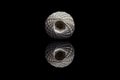 Front view of white ball of string on black background Royalty Free Stock Photo