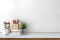 Front view of white desk with coffee mug and house plant. workspace and copy space Royalty Free Stock Photo