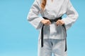 Front view of kimono on little fighter keeping black belt