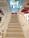 Front view of white staircase inside an office building. Architectural and construction details. Modern and industrial