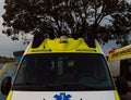 Front view white and yellow ambulance