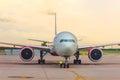 Front view of a wide body aircraft sunset at the airport