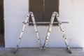 Front view of window frame, ladder and white concrete wall in incomplete house building site Royalty Free Stock Photo