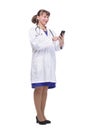 Front view of woman doctor looking at her smartphone while smiling Royalty Free Stock Photo