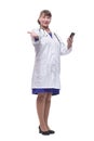 Front view of woman doctor looking at her smartphone while smiling Royalty Free Stock Photo