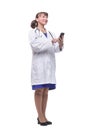 Front view of woman doctor looking at her smartphone while smiling Royalty Free Stock Photo