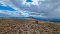 Front view of woman with hiking backpack reaching summit cross of mountain peak Grosser Sauofen Ebersteiner Sau Royalty Free Stock Photo