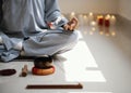 front view woman meditating with incense candles. High quality photo