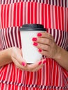 Front view woman in red striped dress holds big paper coffee cup. White latte cup mockup with copy space
