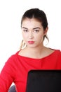 Front view woman sitting at the desk with laptop Royalty Free Stock Photo