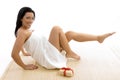 Front view of woman in towel posing with scrubber