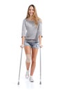 Front view of a woman walking with crutches