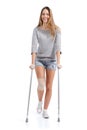 Front view of a woman walking with crutches Royalty Free Stock Photo