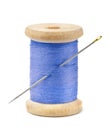 Front view of wood spool of blue thread and needle Royalty Free Stock Photo