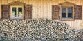 Front view of wooden chalet house with wood stack