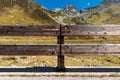 Front view of wooden fence to protect the road in alpine landscape. Spluga Pass