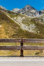 Front view of wooden fence to protect the road in alpine landscape. Spluga Pass