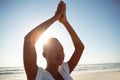 Woman performing yoga on the beach