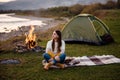 Camping on green meadow on river and mountain background Royalty Free Stock Photo