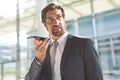 Businessman talking on mobile phone in lobby office Royalty Free Stock Photo