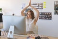 Graphic designer with hand clasped doing yoga in creative office Royalty Free Stock Photo