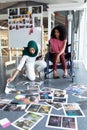 Female graphic designers looking at photographs in office Royalty Free Stock Photo