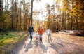 Front view of young family with small children and dog on a walk in autumn forest. Royalty Free Stock Photo