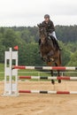 Front view of young horsewoman jumping. Vertically.