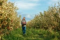 Front view young man farmer orchard worker stand hold crate full ripe red apples. Royalty Free Stock Photo