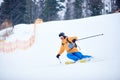 Proficient young skier concentrated on skiing down on steep ski slope. Extreme winter activities concept. Front view