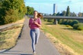 Young smiling woman running along river Royalty Free Stock Photo