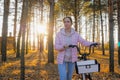 Young woman walking with bicycle in autumn city park - front view Royalty Free Stock Photo