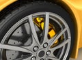 Front wheel of a bright yellow car Royalty Free Stock Photo