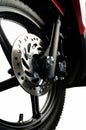 a front wheel disc brake of red scooter type motorbike Royalty Free Stock Photo