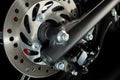 a front wheel disc brake of red scooter type motorbike Royalty Free Stock Photo