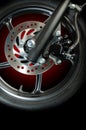 a front wheel disc brake of red scooter type motorbike Royalty Free Stock Photo