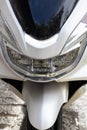Front wheel and headlight with windshield of a motorbike. Motorcycle, front view Royalty Free Stock Photo