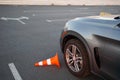 Front Wheel of Learner Car Touching Traffic Cone on Practice Course. Royalty Free Stock Photo