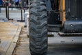 Front wheel of a wheeled tractor standing on the road. Street renovation